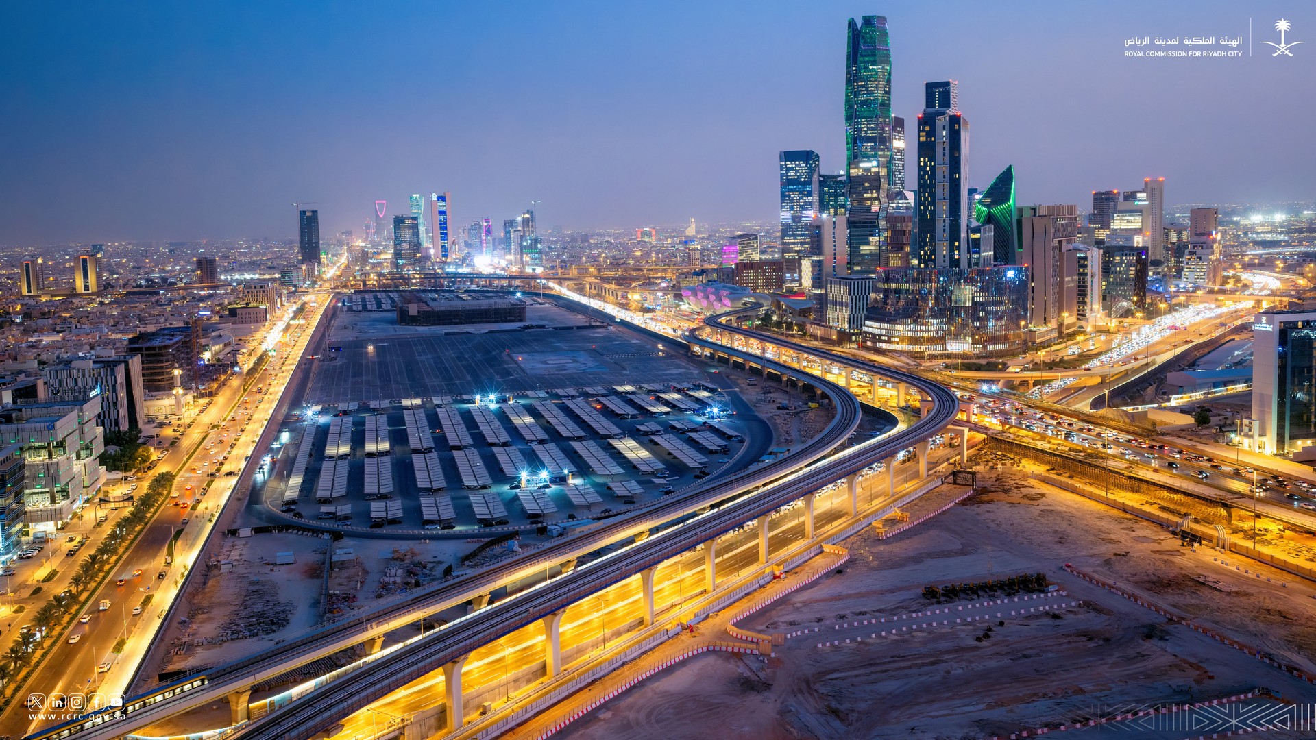 Aerial dusk view of the elevated Riyadh Metro line and surrounding roads near King Abdullah Financial District
